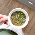 woman holding a cup of loose leaf sweet dreams tea
