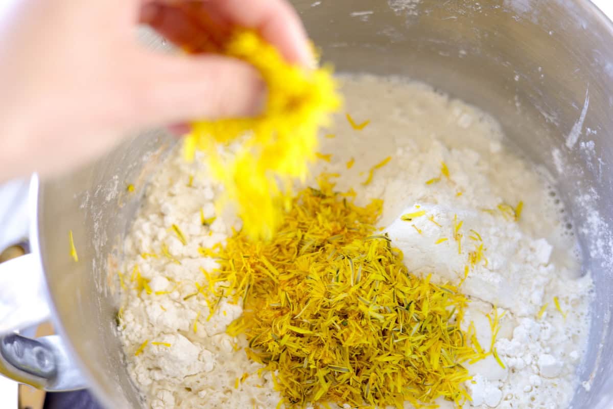 adding dandelion flowers to the dough