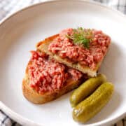 garlic toast with steak tartare and pickles on the side