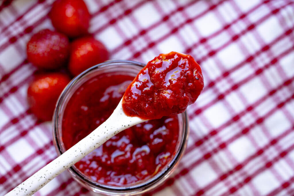 a jar of jam with strawberries 