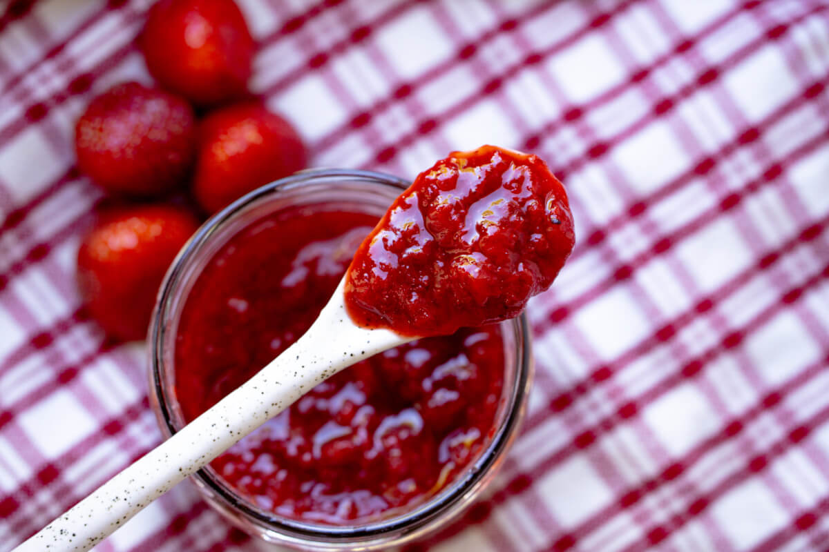 a jar of jam with strawberries