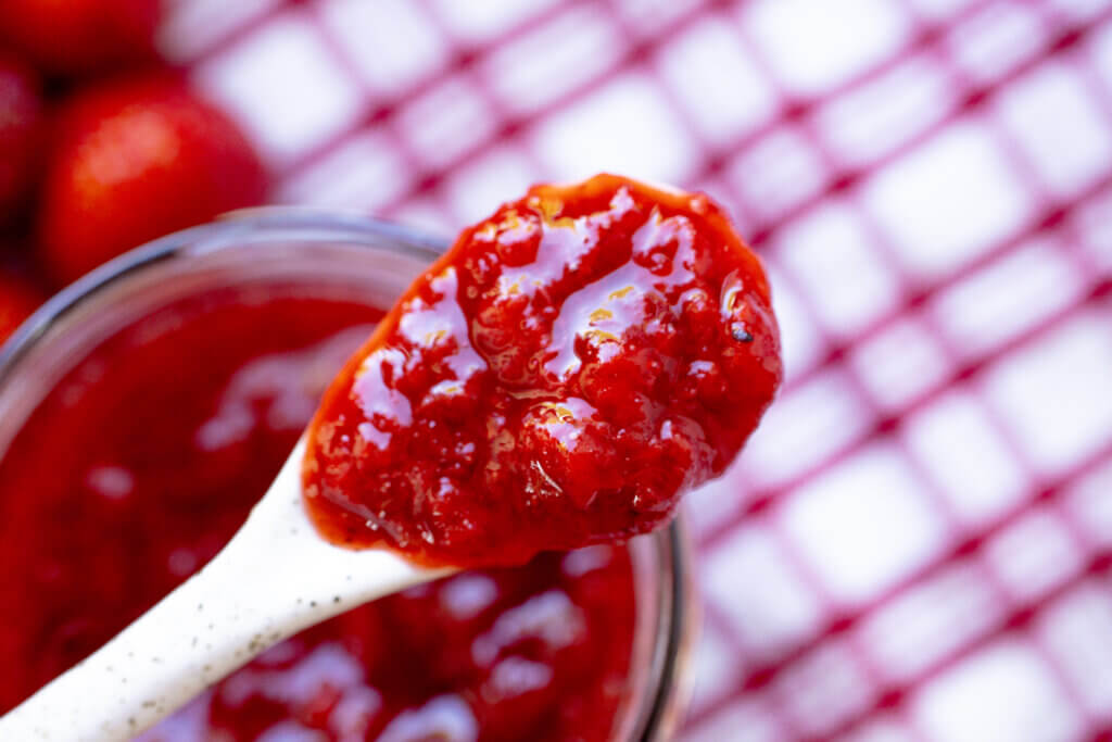 a close up of strawberry jam on a spoon