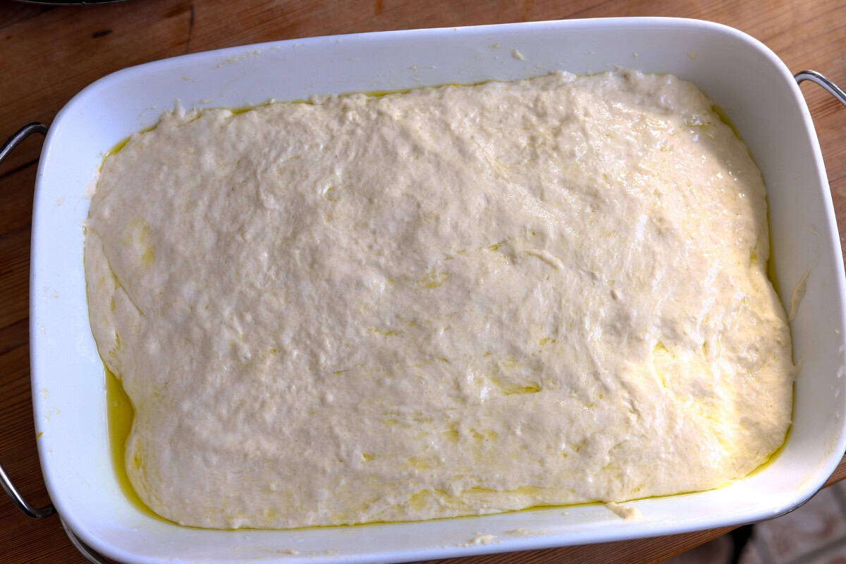 poured focaccia dough into the baking dish