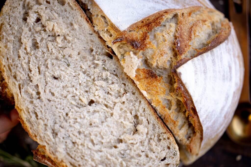 a close up of sliced rosemary sourdough bread 