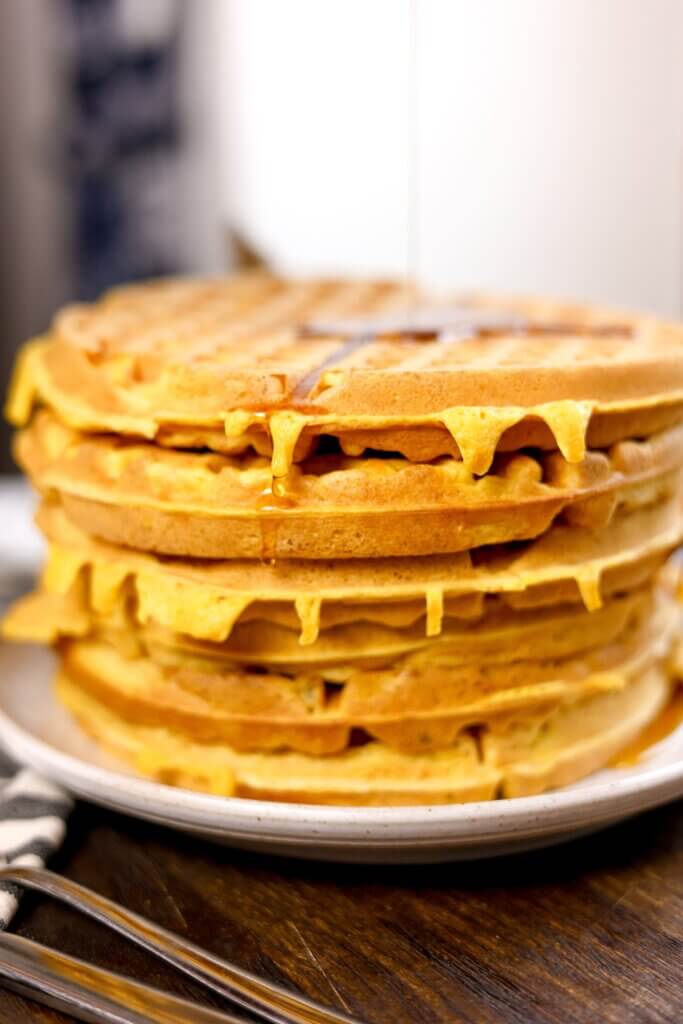 stacked sourdough pumpkin waffles with maple syrup