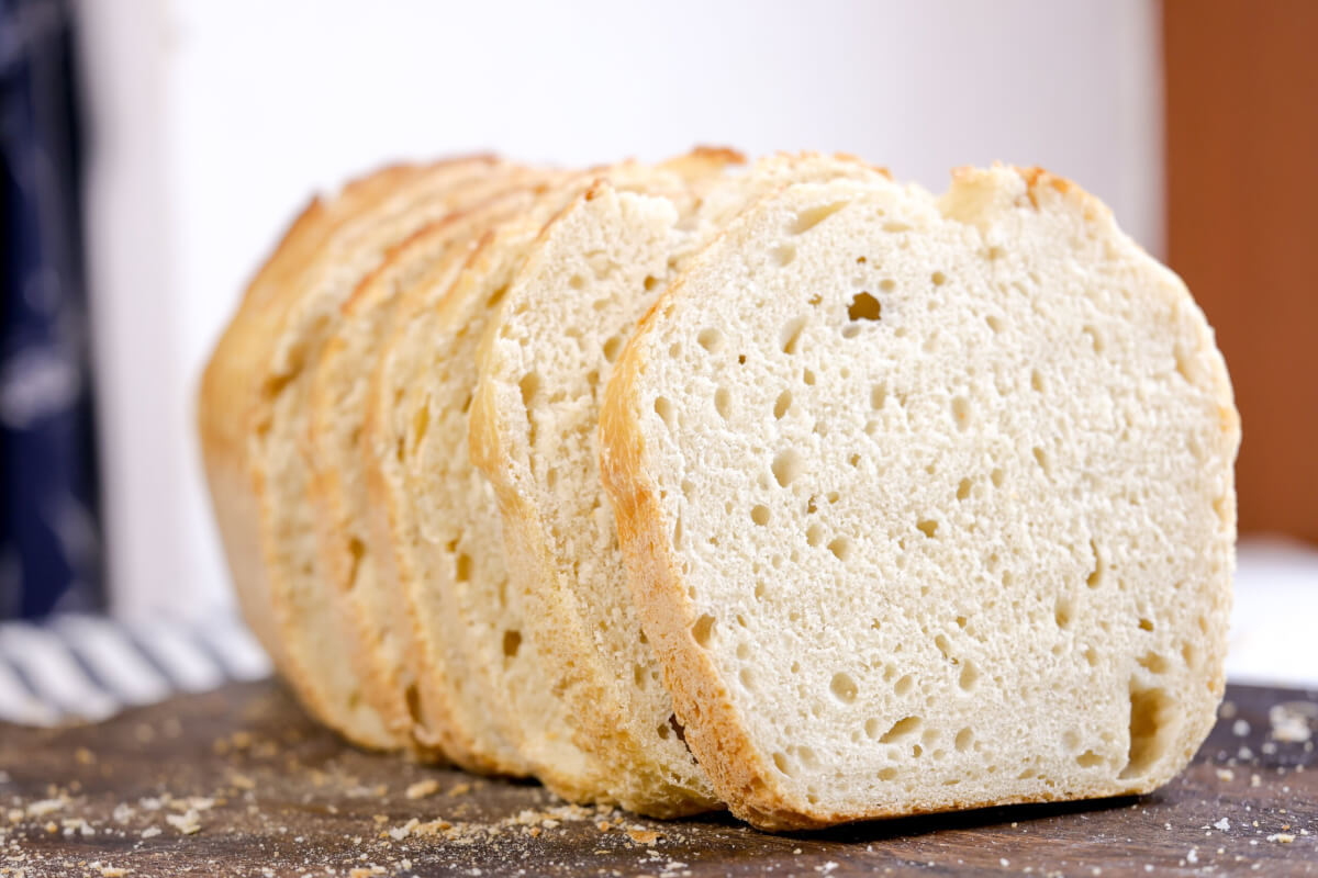 sliced sourdough sandwich bread on a wooden board