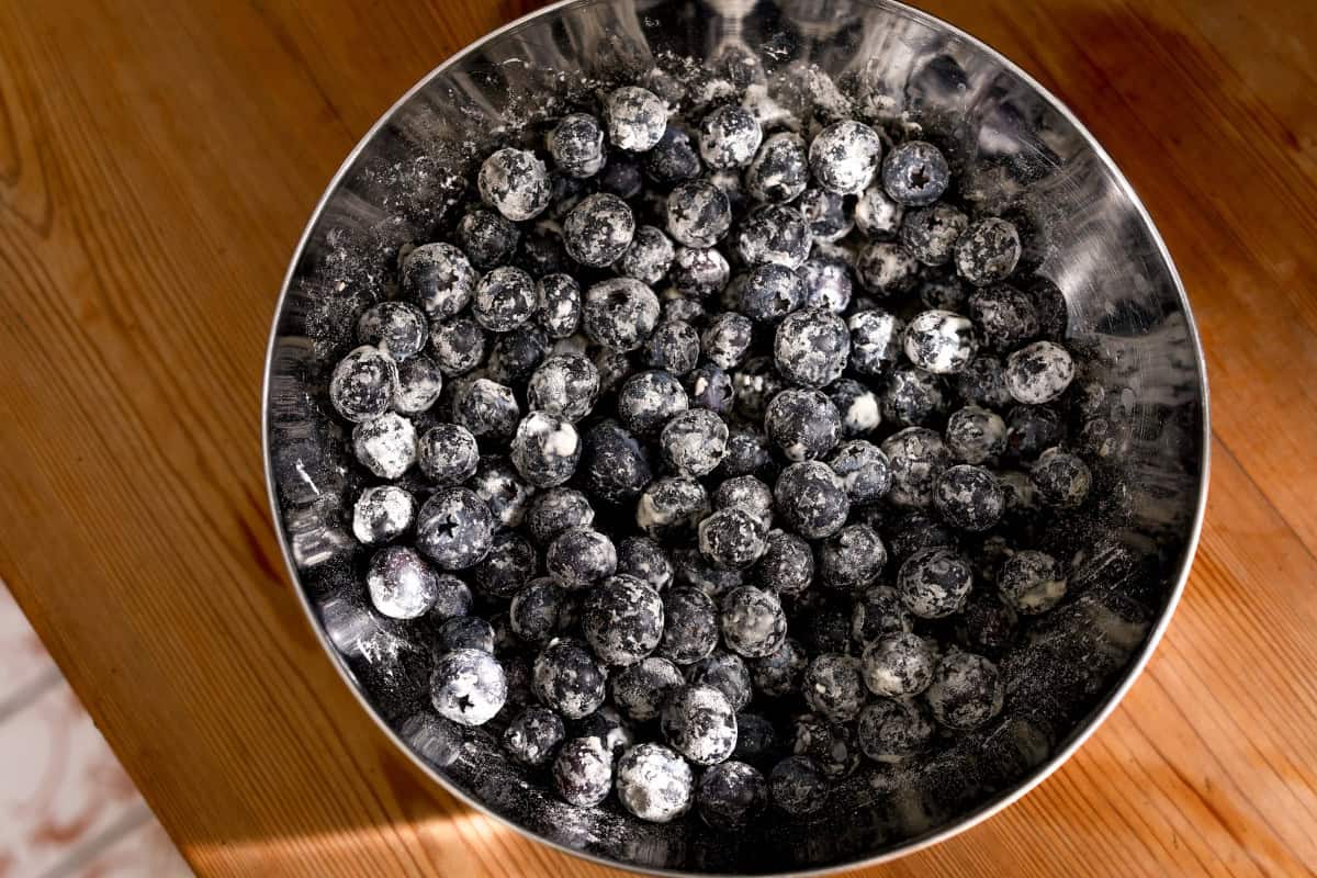blueberries coated with flour in a bowl