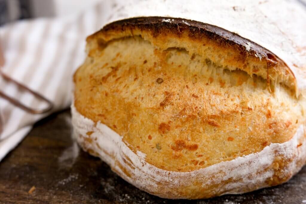 scored part of sourdough cheddar jalapeno bread