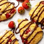 Golden baked strawberry scones with melted chocolate drizzle