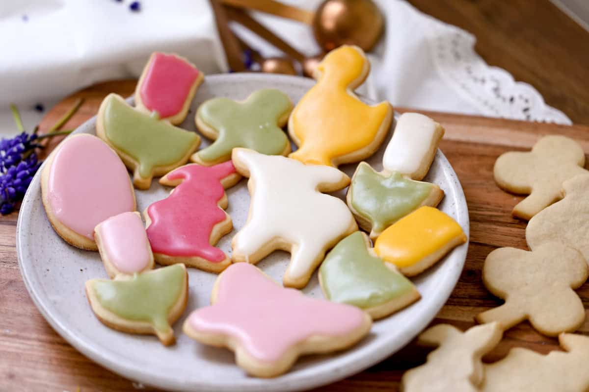 a plate full of cookies decorated with different glaze